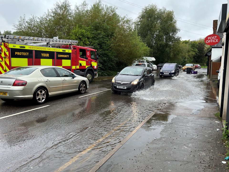 Firefighters pumping water out of homes on Woolgrove Road along the River Purwell in Hitchin this morning