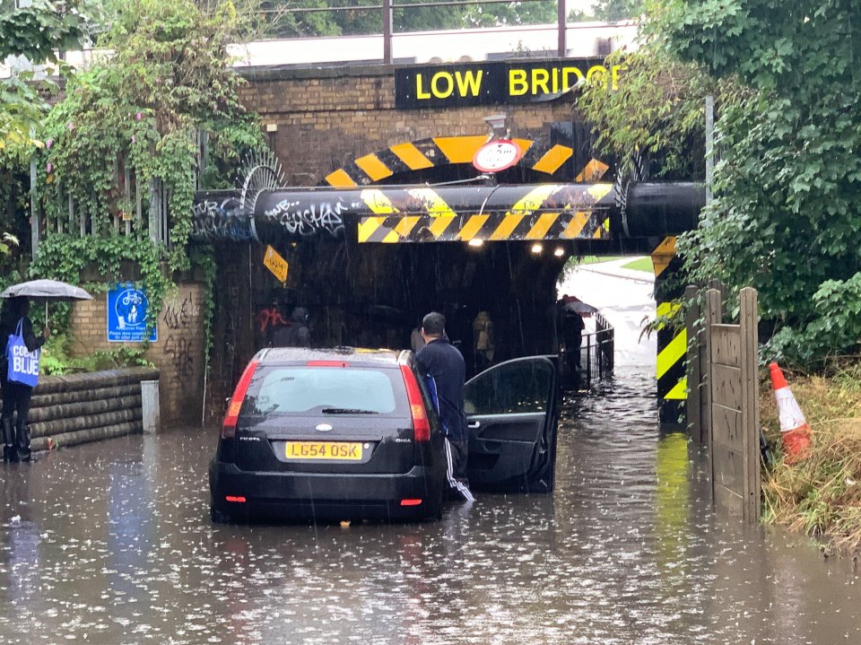 Chaos in Slough, Berkshire, after a driver got his car stuck in floodwater underneath Station Road railway bridge