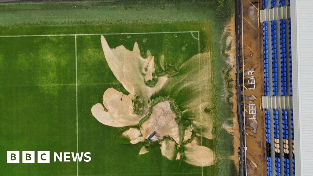 Drone video of sinkhole in football pitch after floods