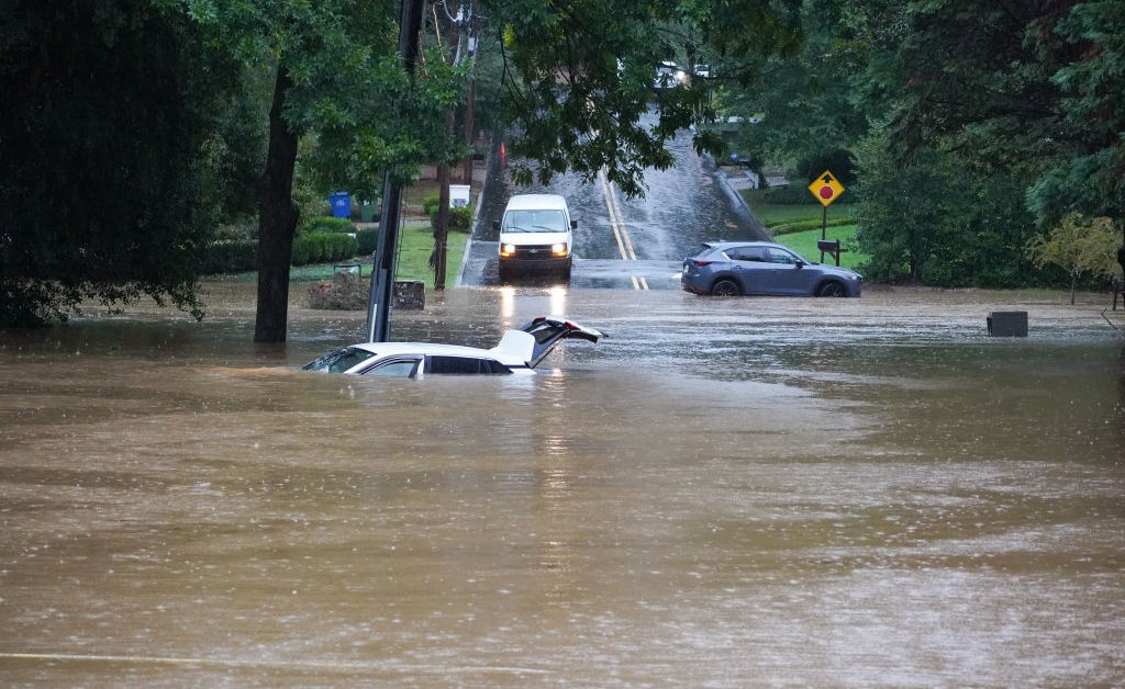 Watch: TV Reporter Rescues Woman Trapped in Submerged Car