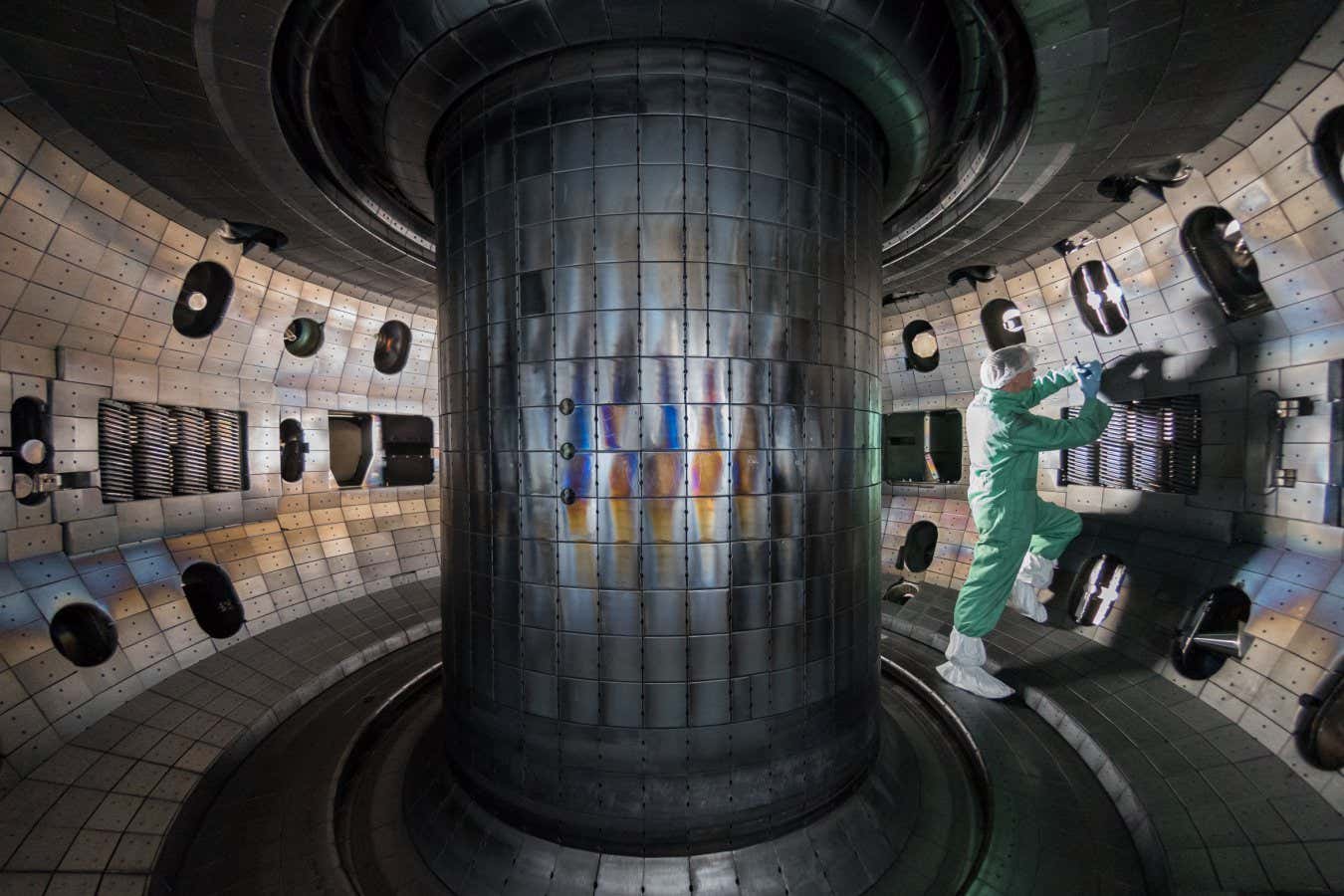 A worker inside the vacuum vessel of the DIII-D fusion reactor