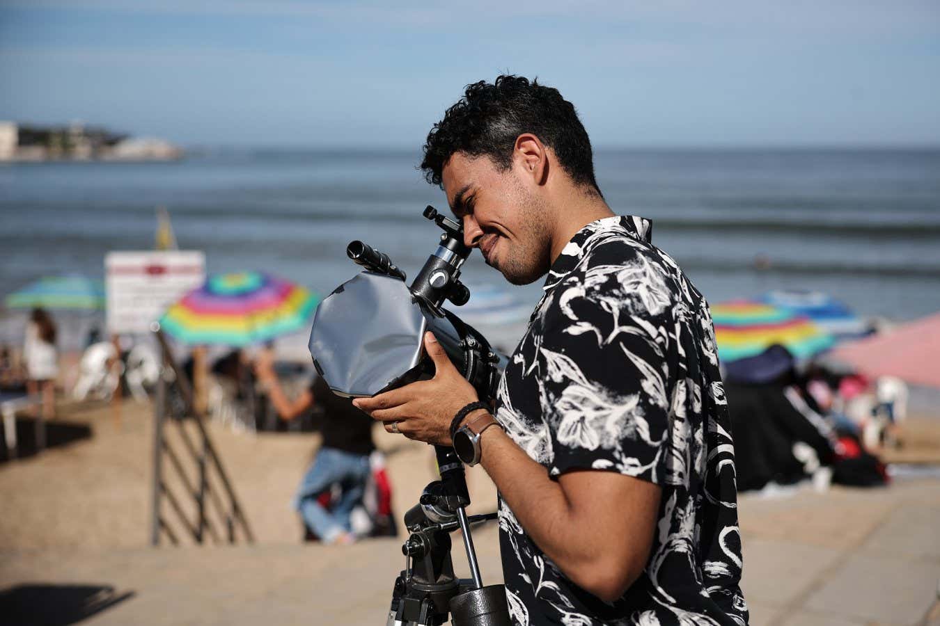 MAZATLAN, MEXICO - APRIL 08: A man prepares his telescope to see the eclipse on April 08, 2024 in Mazatlan, Mexico. Millions of people have flocked to areas across North America that are in the