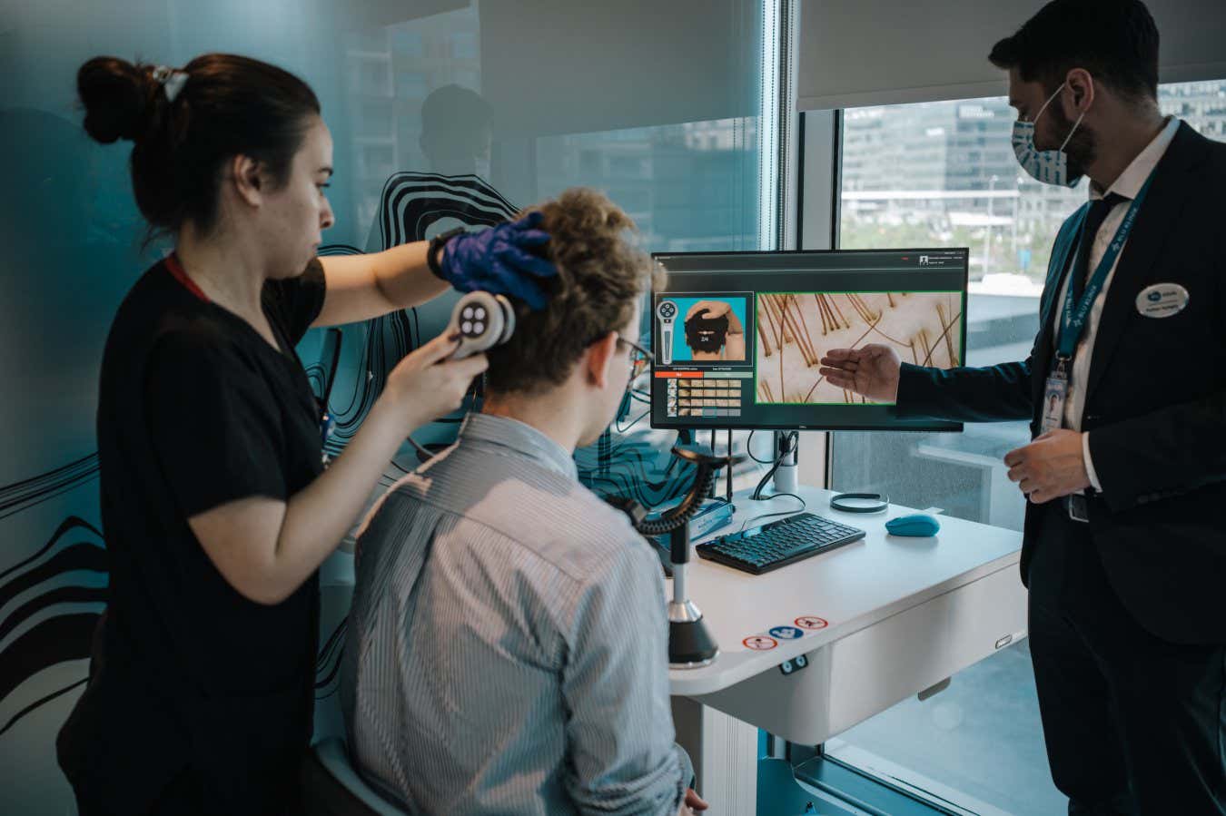 Members of the medical staff at the Elithair clinic conduct an artificial Intelligence analysis of Felix Hofmann