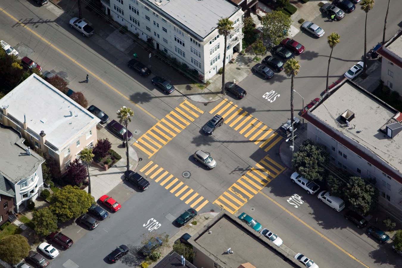 AC4ABH aerial view above four way urban intersection San Francisco, California