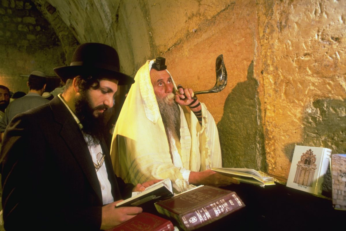 Orthodox Jews pray and blow a shofar at the Western Wall during Rosh Hashanah. Jerusalem, Israel.