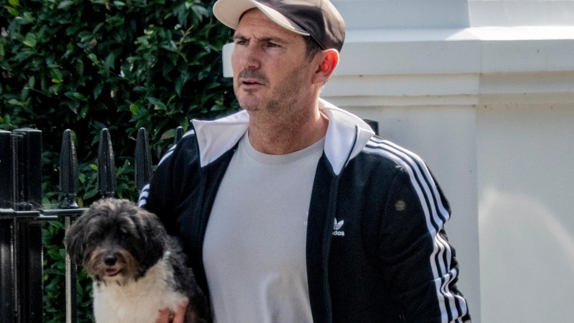 Chelsea legend Frank Lampard carries adorable puppy while out for a walk near his London home