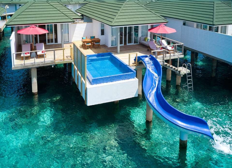 You can stay in an overwater villa complete with a helter-skelter slide