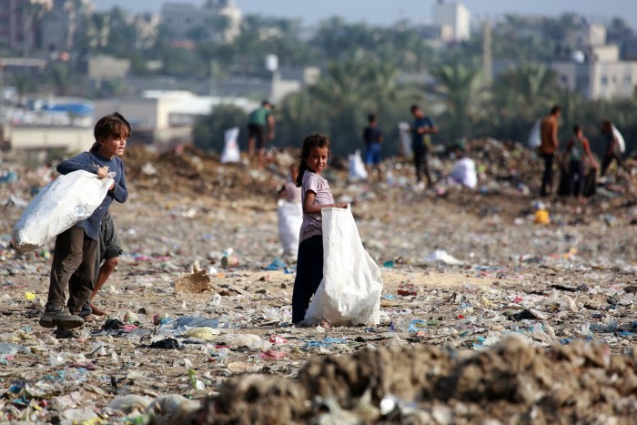 Children sift through waste at a landfill in Khan Younis in the southern Gaza Strip on October 15 2024