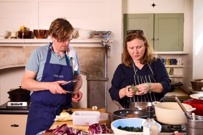 The picture shows Angela Hartnett and Neil Borthwick working together on preparing the main course in their Shoreditch kitchen