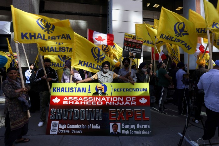 Protesters hold yellow flags with the word Khalistan, as well as a banner with the picture of Sikh separatist leader Hardeep Singh, during a protest outside India’s consulate in Toronto last year