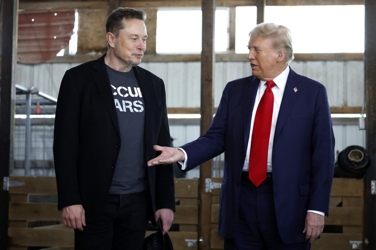 BUTLER, PENNSYLVANIA - OCTOBER 05: Republican presidential nominee, former President Donald Trump offers his hand to Elon Musk back stage during a campaign rally at the Butler Farm Show grounds on October 05, 2024 in Butler, Pennsylvania. This is the first time that Trump has returned to Butler since he was injured during an attempted assassination on July 13. (Photo by Anna Moneymaker/Getty Images)