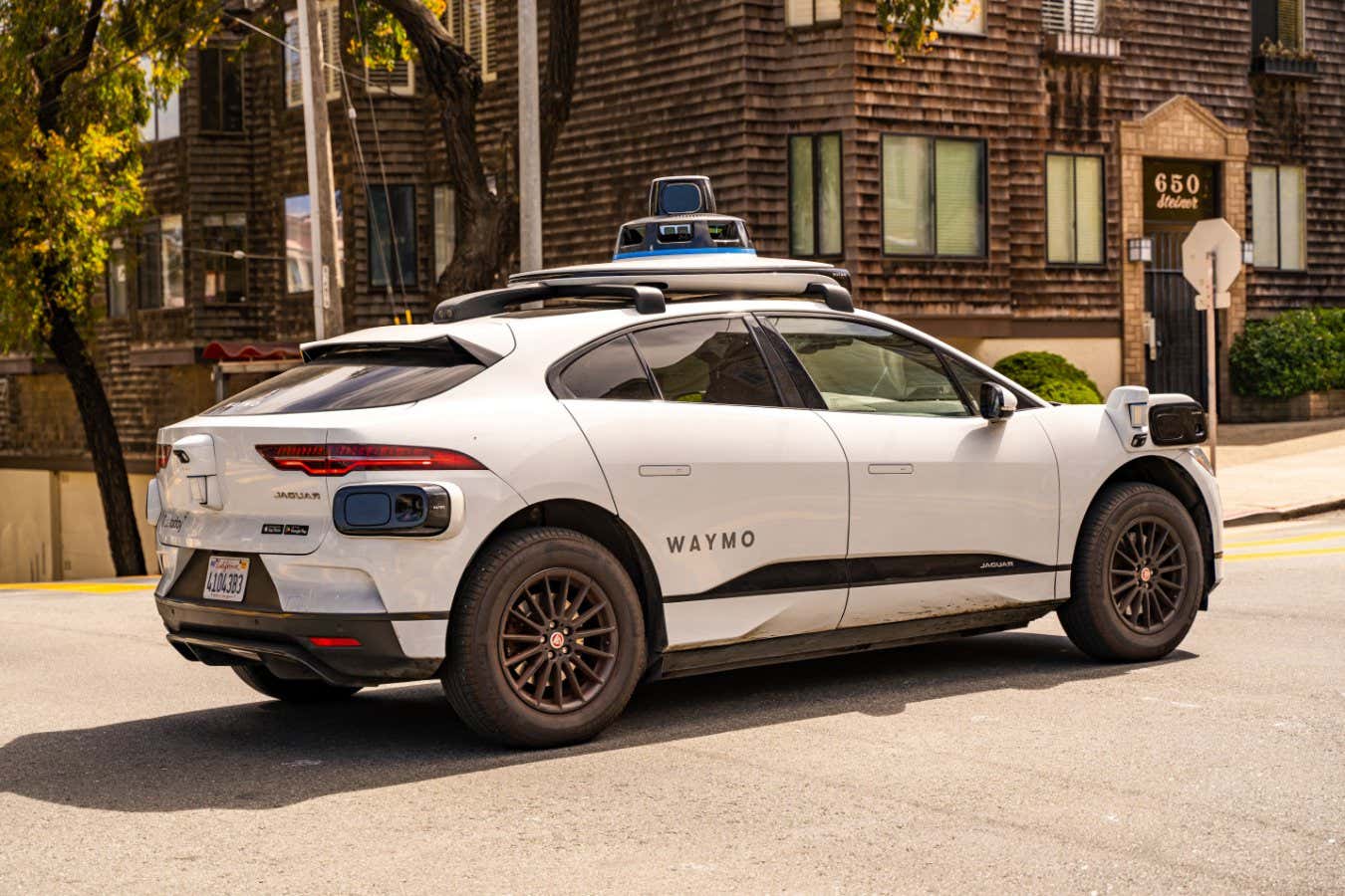 San Francisco, CA, USA - September 15, 2024: Waymo self driving taxi driving in downtown San Francisco; Shutterstock ID 2517479849; purchase_order: -; job: -; client: -; other: -