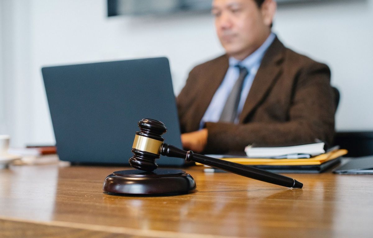 Judge sitting behind laptop in office