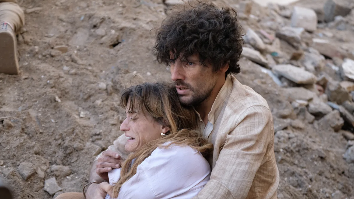 A distraught Robin (Toni O'Rourke) is held by Harry (Colin Morgan) in the rubble of an earthquake in