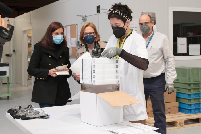 A worker removes a new shipment of Pfizer/BioNTech Covid-19 vaccine from a box at the Riofarco pharmaceutical laboratory