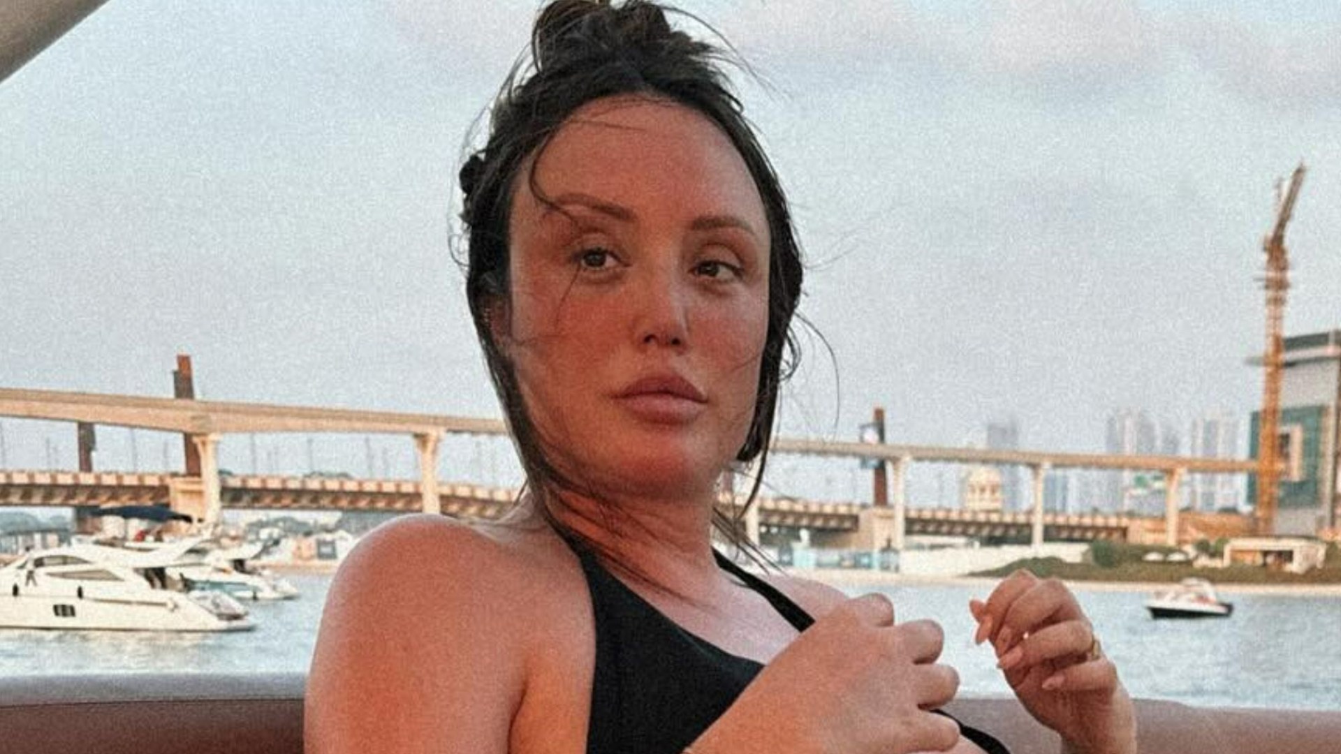 Charlotte Crosby shows off blossoming baby bump in black bikini as she relaxes on a yacht on Dubai getaway