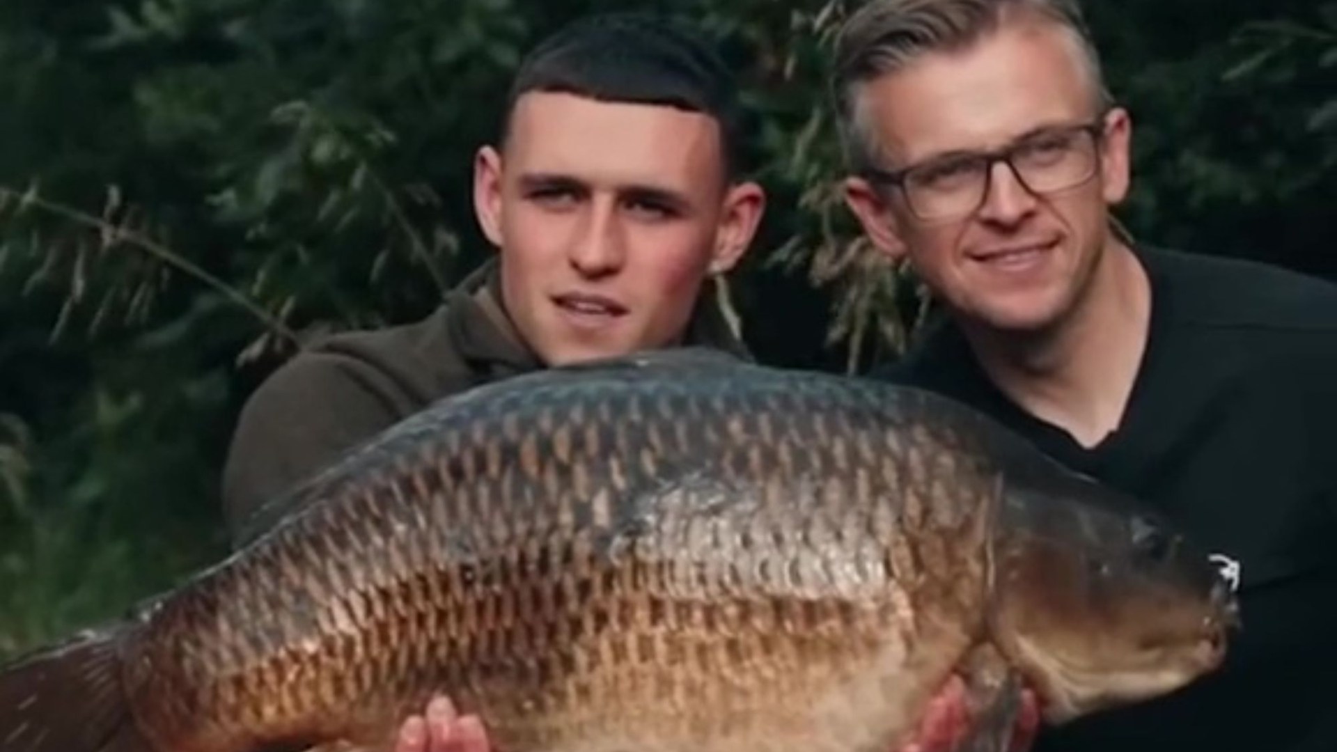 England ace Phil Foden yells 'it's a big one' as he bags monster carp on fishing trip with TV expert