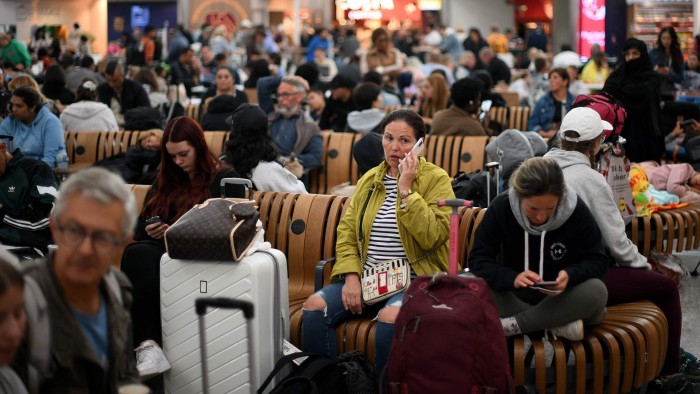 Passengers wait at London’s Stansted airport during the August bank holiday chaos in 2023