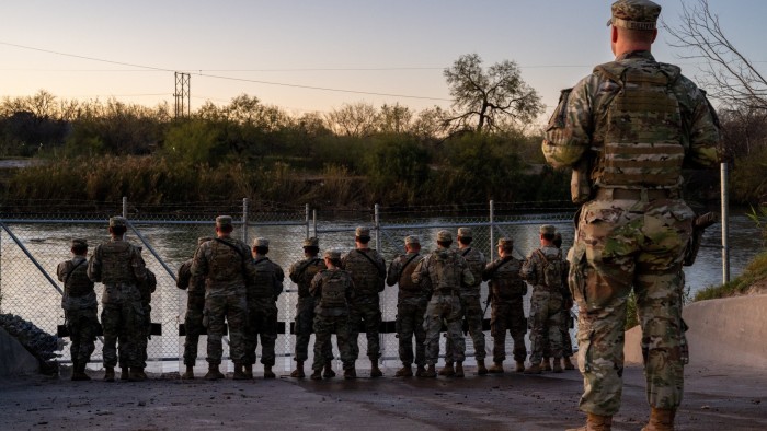 National Guard soldiers stand guard on the banks of the Rio Grande river at Shelby Park on January 12, 2024 in Eagle Pass, Texas