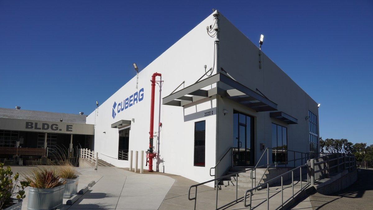 Cuberg's old manufacturing facility stands against a blue sky.