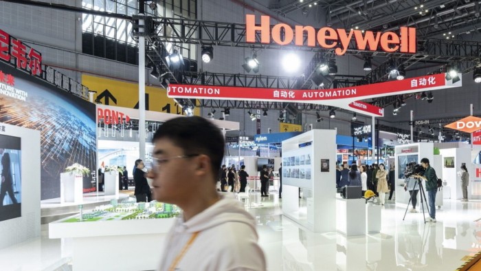 A man walks past the Honeywell booth at the China International Import Expo in Shanghai