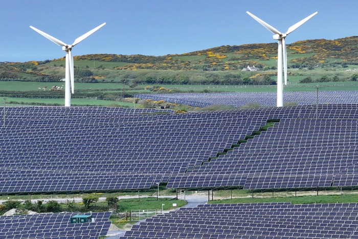 Wind turbines next to the North Anglesey solar project in Wales