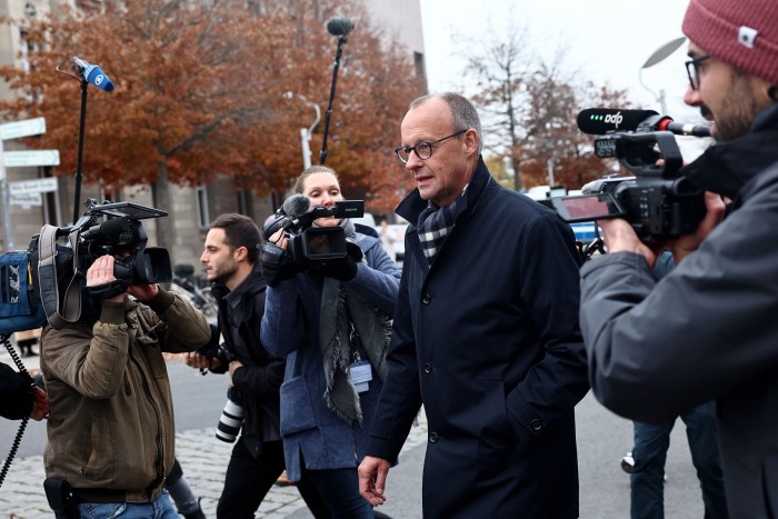 German opposition leader Friedrich Merz arrives at the Chancellery in Berlin on Thursday