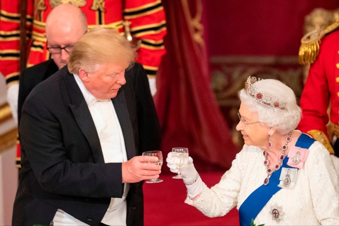 Donald Trump, left, and Queen Elizabeth II raise their glasses towards each other during a state banquet at Buckingham Palace in 2019