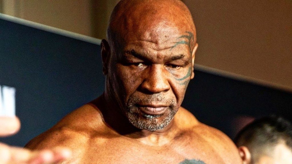 Mike Tyson steps on the scale for Jake Paul fight