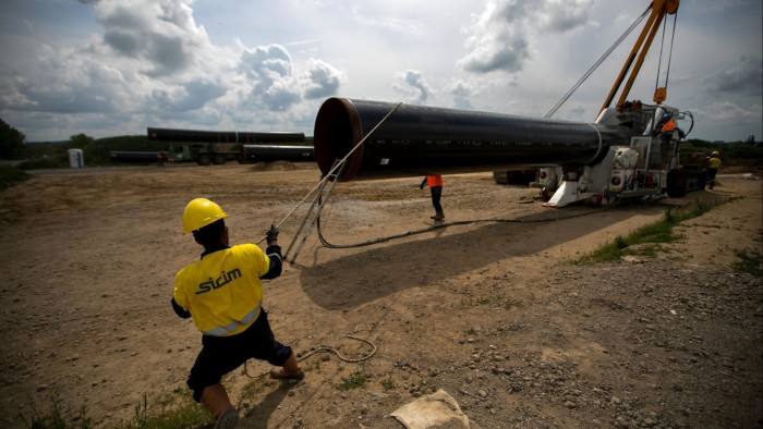 Workers bend a section of gas pipeline on the European Gas Pipeline Link (EUGAL) site, a joint construction project by Sicim SpA and Bohlen & Doyen GmbH, in Gellmersdorf, Germany,