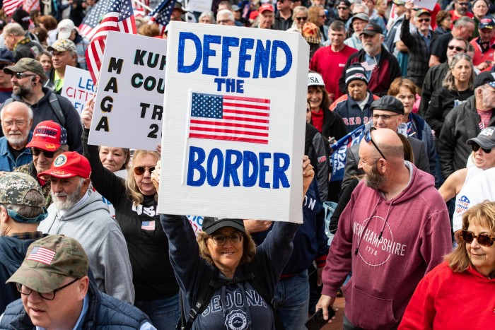 Demonstrators at a rally in Boston, Massachusetts, US in May 2024. One demonstrator is holding up a sign that says ‘Defend the border’