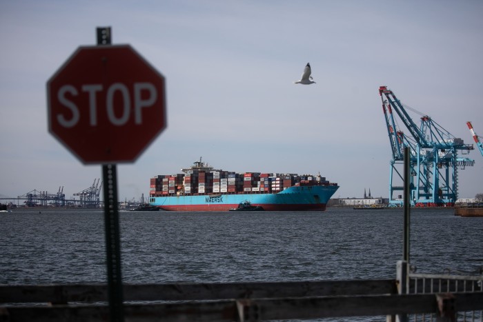 Tugboats guide the Maersk Atlanta container ship at the Port of Newark in Newark, New Jersey, US