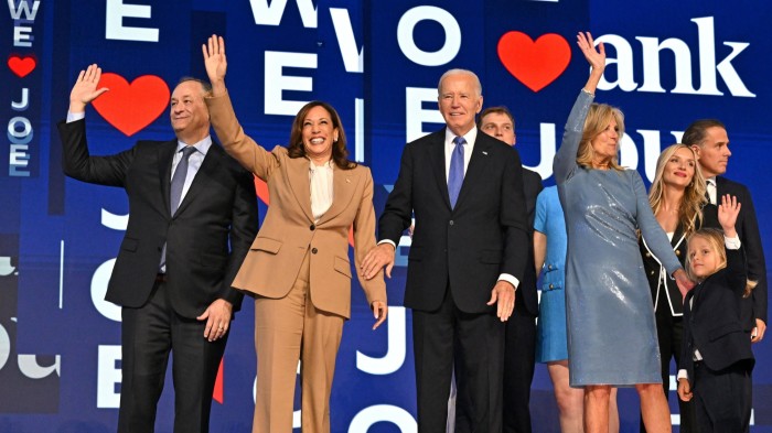 Kamala Harris and Joe Biden and their families wave to supporters from the stage