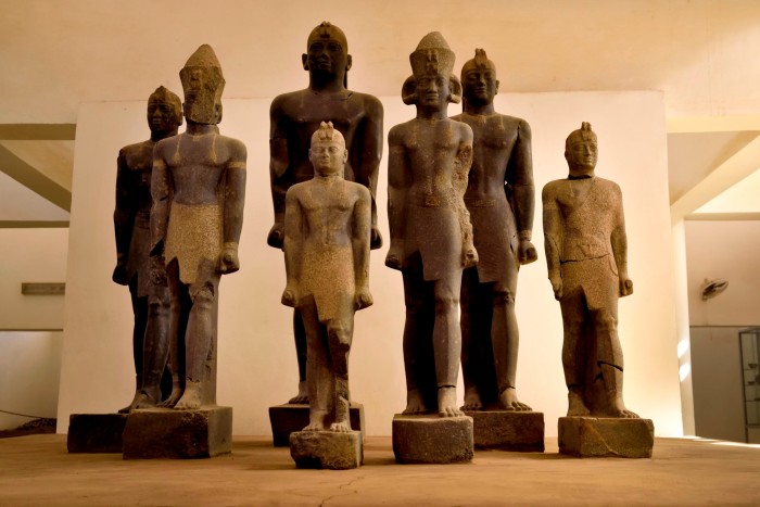 The seven statues stand in a museum. Some are up to 10 feet tall