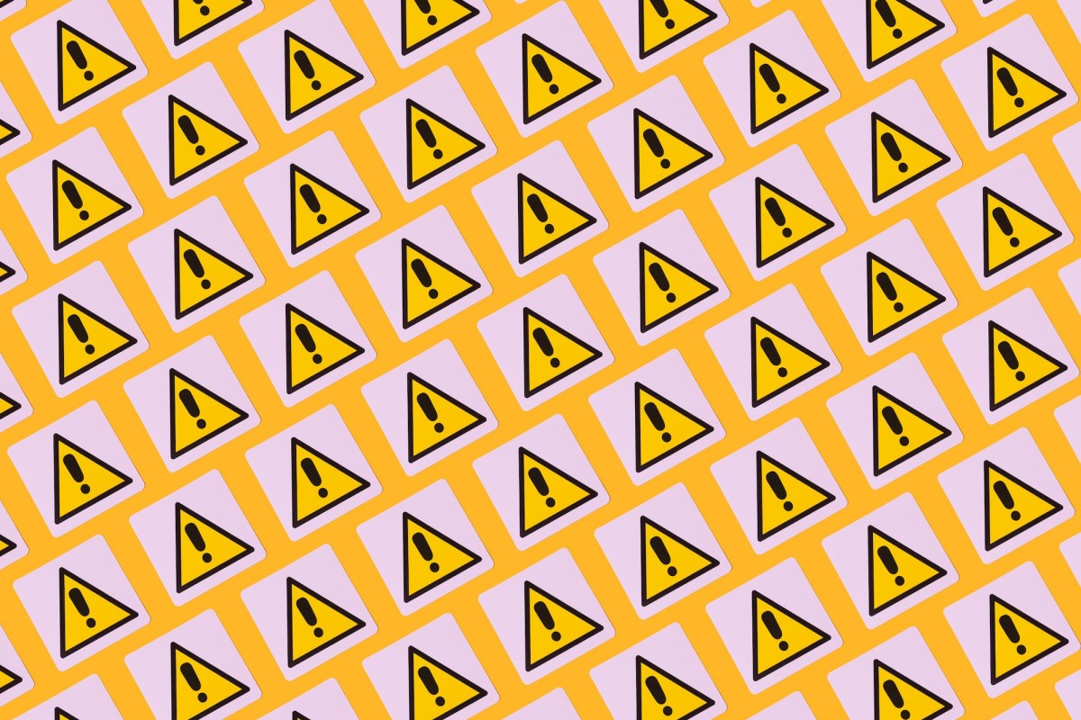 yellow warning symbols with exclamation points on a patterned background