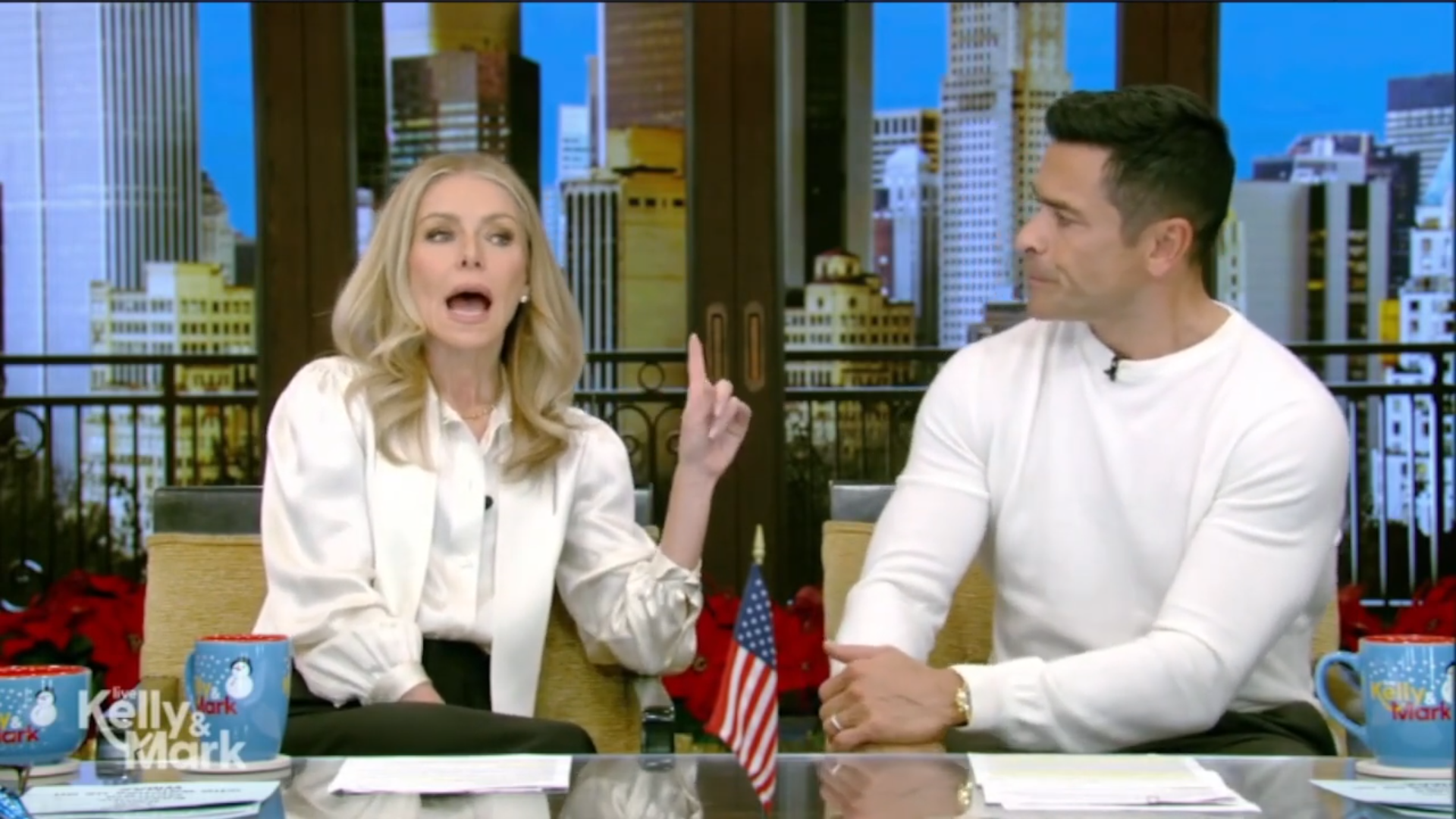 Mark Consuelos listens as Kelly Ripa speaks on Live with Kelly and Mark.