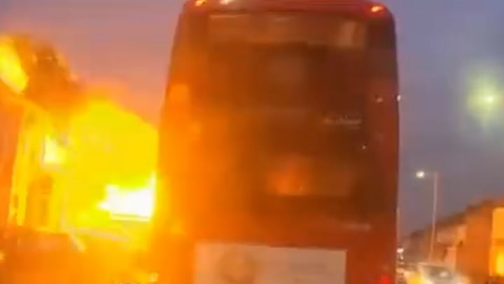 Moment house explodes in fireball metres away from bus