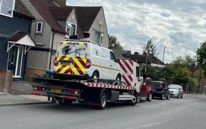 A Ulez enforcement van is towed away in Crayford, Bexley, after being daubed with graffiti and having its tyres slashed - Triangle News