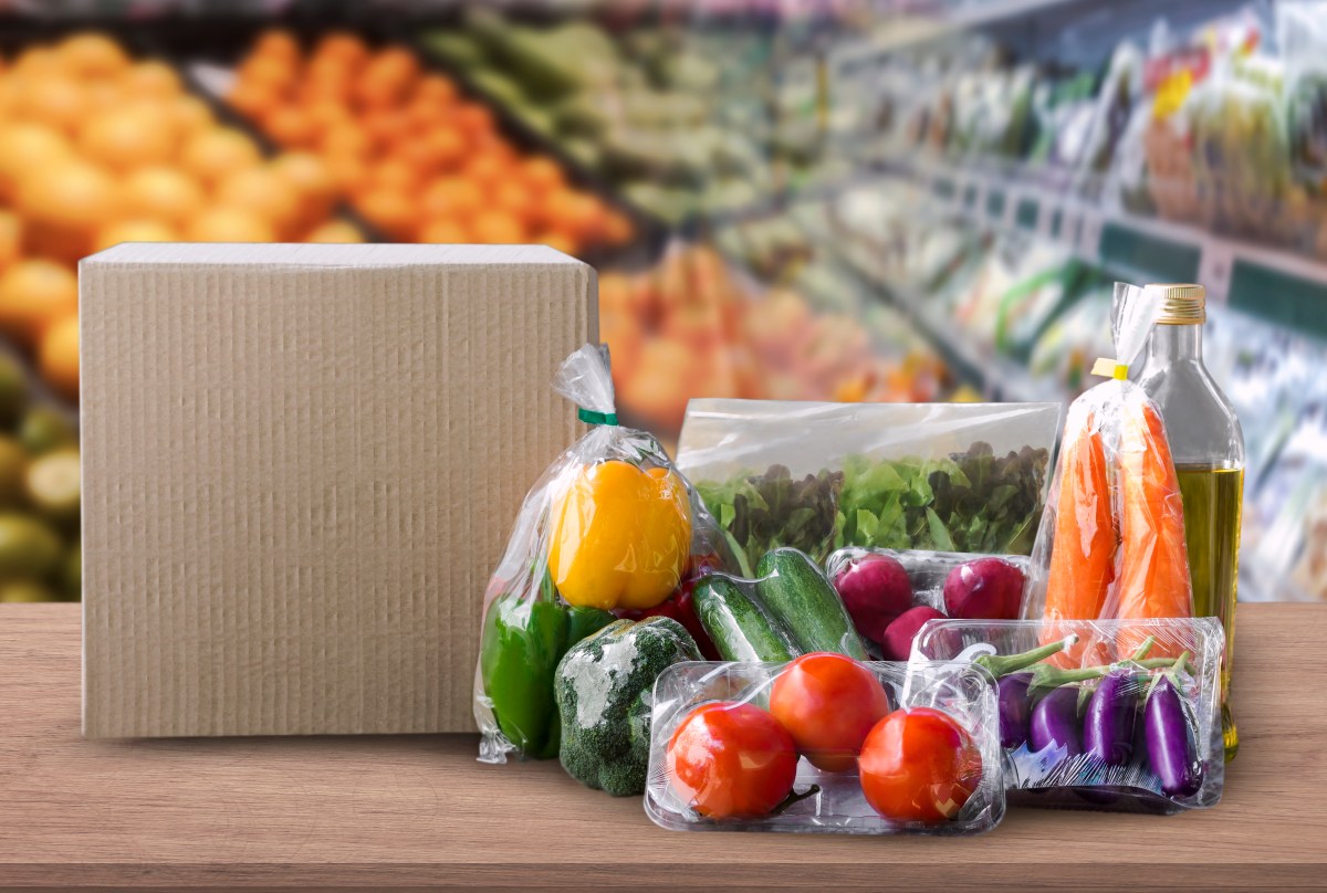 Packaged food on wood table with supermarket background