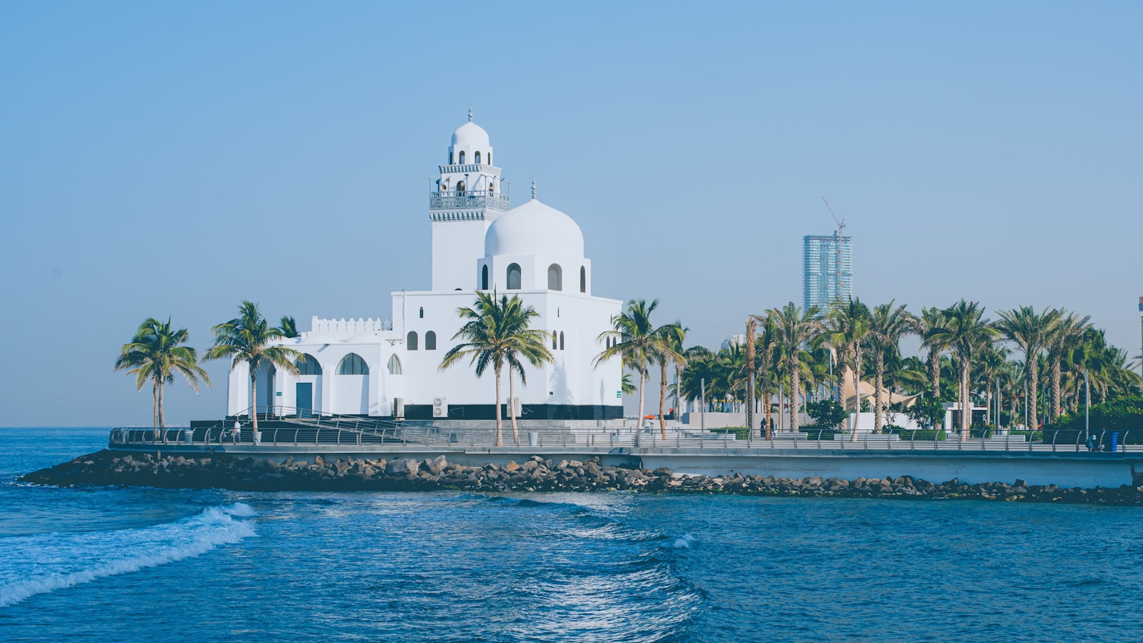 white concrete building near body of water during daytime