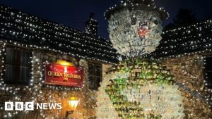 Wine-bottle snowman towers 26 feet over Mendips pub