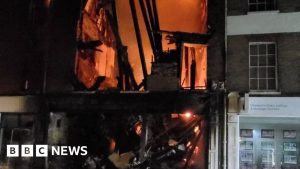 Cafe partially collapses as fire engulfs building