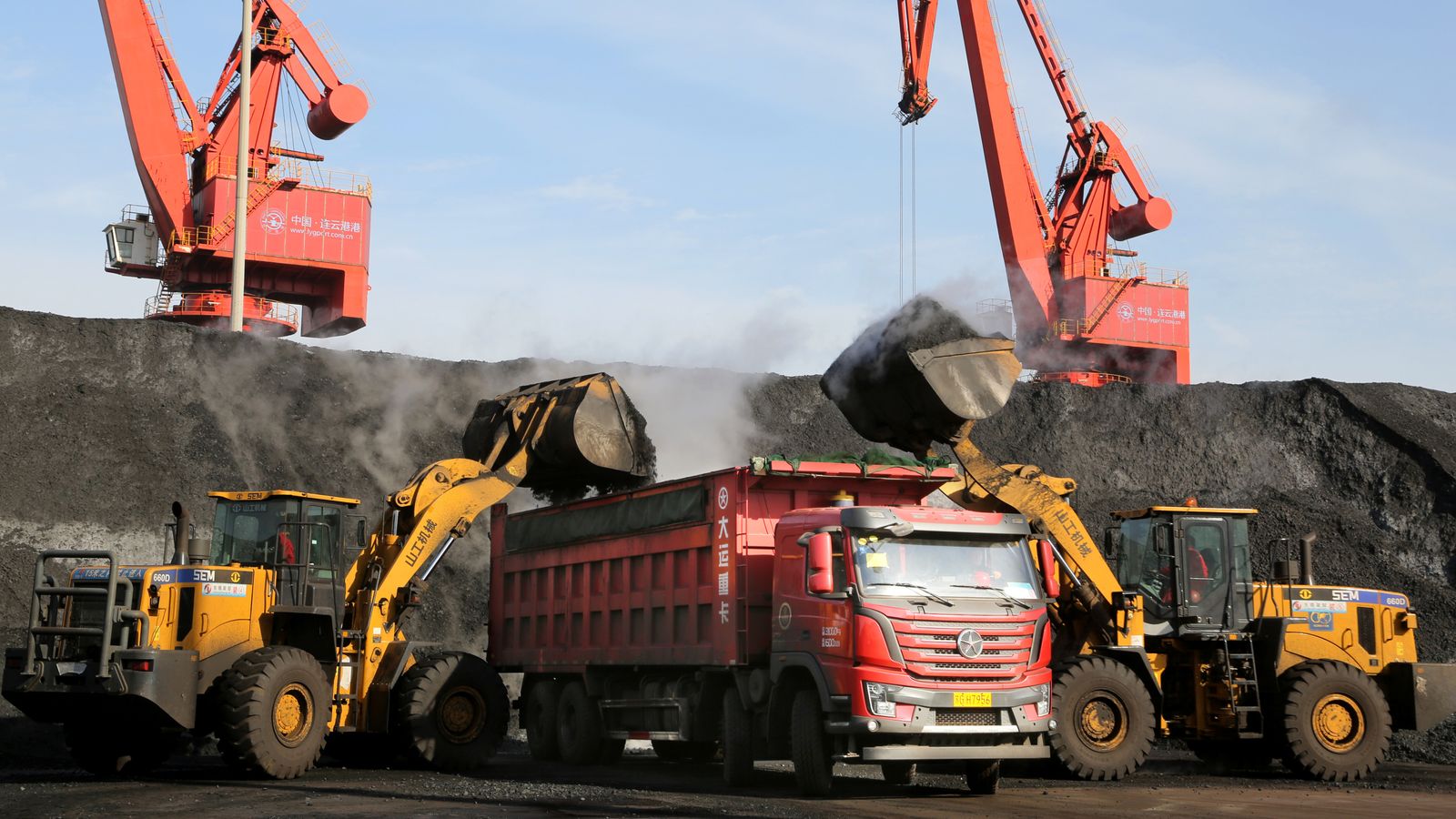 Loaders transport coal to a truck at a port in Lianyungang, Jiangsu province, China. Pic: Reuters