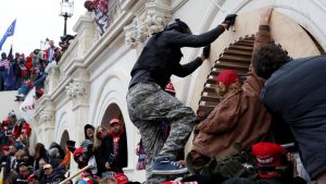 Trump supporters scale the wall of the Capitol Building in Washington DC on 6 January 2021. Pic: Reuters