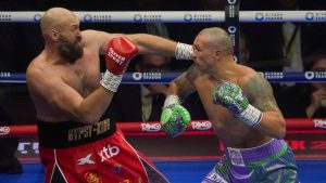 Boxers Britain's Tyson Fury, left, and Ukraine's Oleksandr Usyk compete during their WBA, WBO, and WBC world heavyweight title fight in Riyadh, Saudi Arabia, Saturday, Dec. 21, 2024. (AP Photo/Frank Augstein)