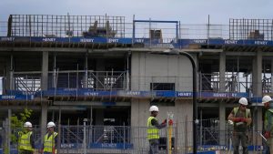 Construction workers on a site in London, Friday, Sept. 23, 2022. Britain's new government on Friday announced a sweeping plan of tax cuts it said would be funded by borrowing and revenues generated by anticipated growth, as part of contentious moves to combat the cost-of-living crisis and bolster a faltering economy. (AP Photo/Kirsty Wigglesworth)