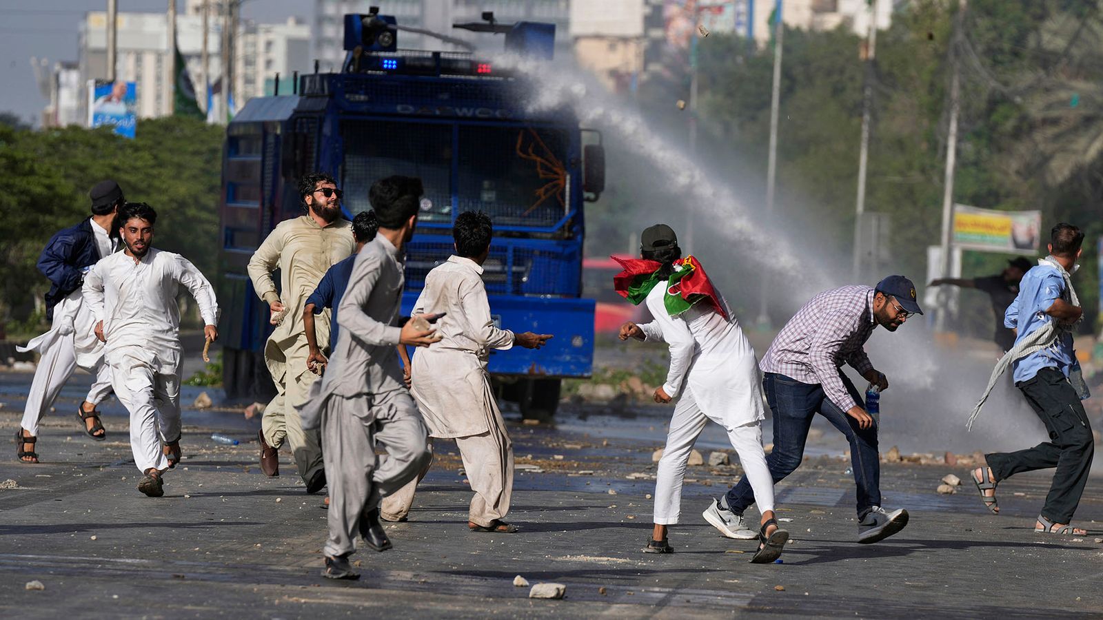 Police use a water cannon to disperse supporters of Pakistan's former Prime Minister Imran Khan protesting against the arrest of their leader, in Karachi, Pakistan, Tuesday, May 9, 2023.  Khan was arrested Tuesday as he appeared in a court in the country...s capital, Islamabad, to face charges in multiple graft cases. Security agents dragged Khan outside and shoved him into an armored car before whisking him away. (AP Photo/Fareed Khan)