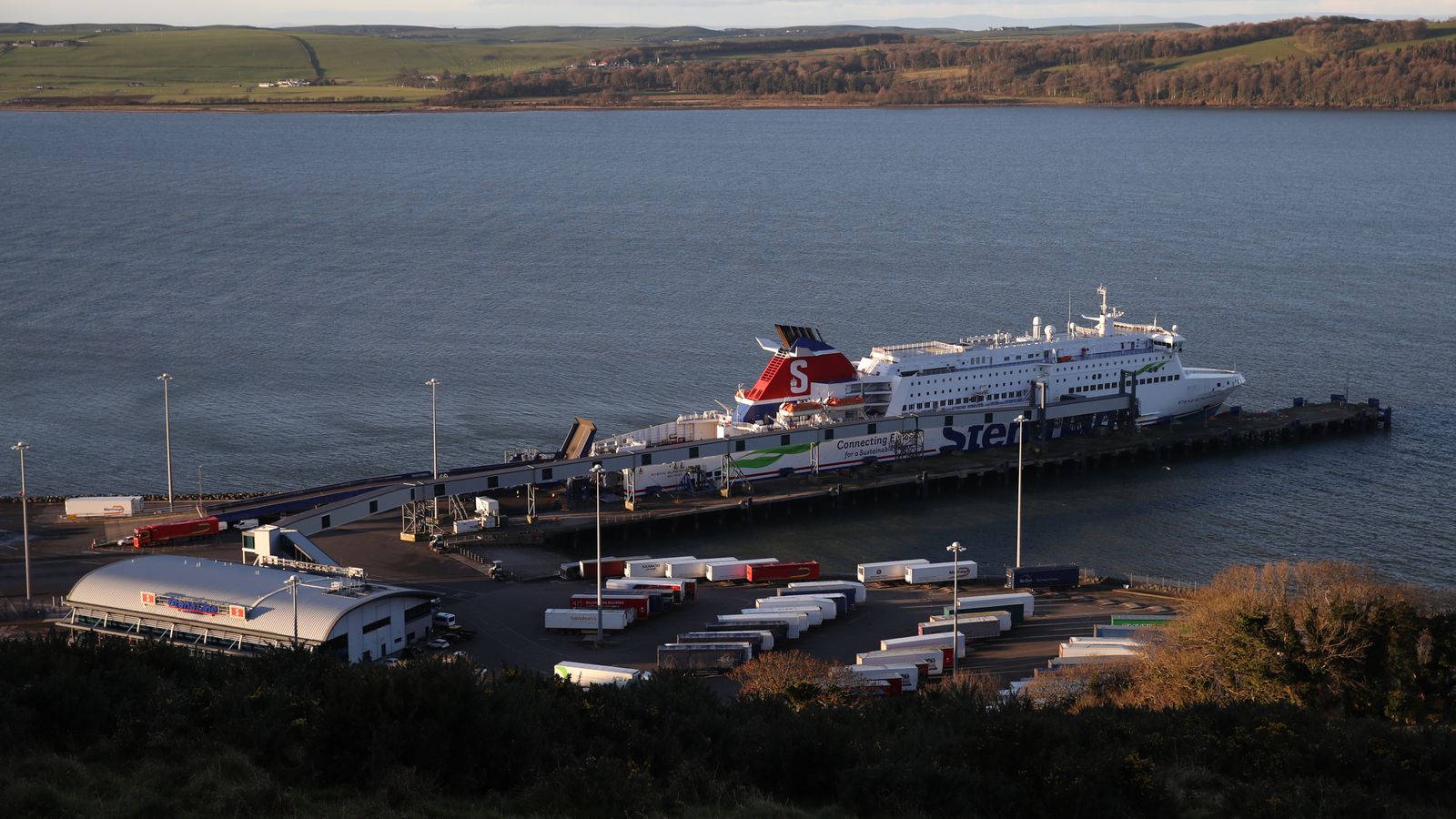 Man arrested after Albanian nationals found hidden in livestock wagon at Scottish port | UK News