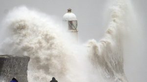 Waves crash over the seafront in Porthcawl in Wales. Millions have been warned to stay indoors, thousands are without power and trains have been cancelled as the Government's "risk to life" alert brought on by Storm Darragh came into force. Picture date: Saturday December 7, 2024. PA Photo. Photo credit should read: Ben Birchall/PA Wire