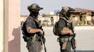 Members of the Kurdish-led Syrian Democratic Forces (SDF), backed by the US to fight ISIS, hold their weapons in Hasaka, Syria on 6 December. Pic: Reuters